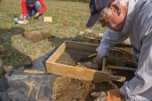 Image of volunteers working at a dig site